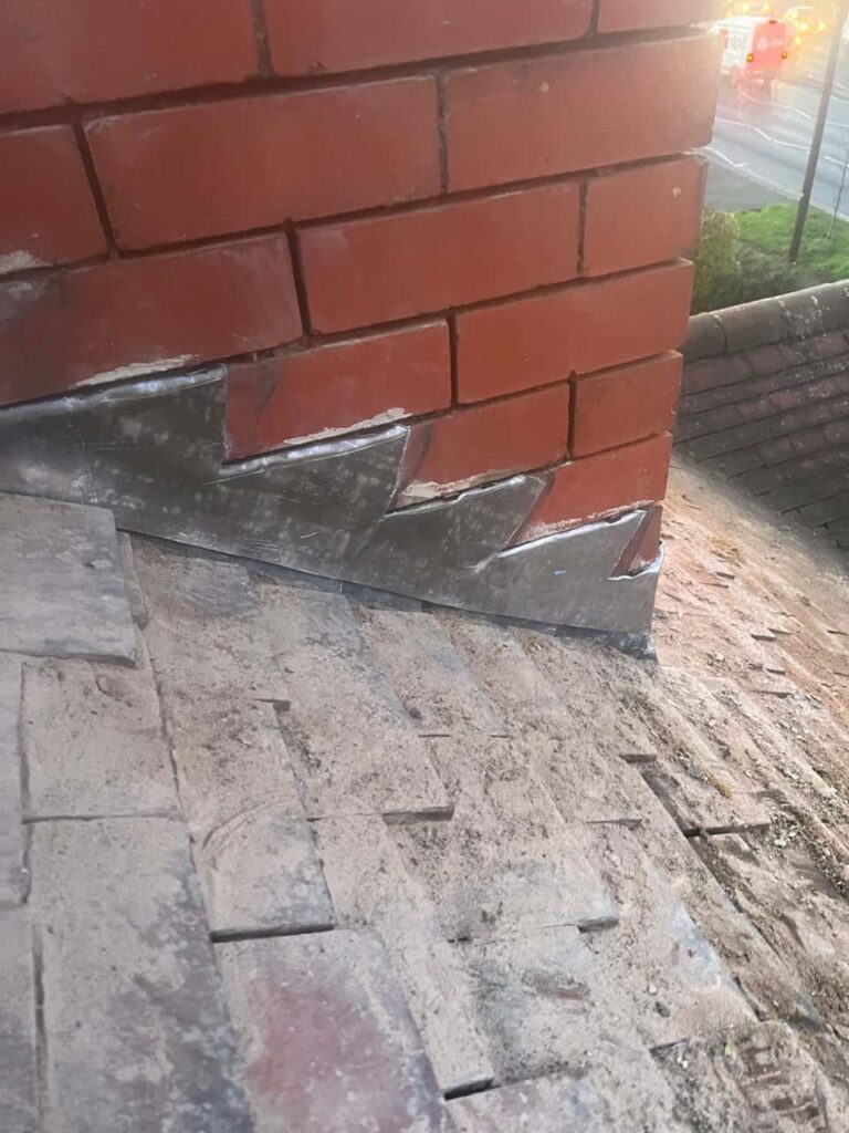 This is a photo of new leadwork being installed around an old chimney. Works carried out by MCM Roofing Repairs Tisbury